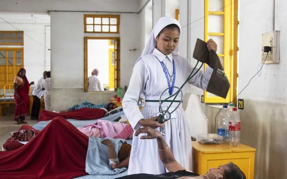 Sister Falguni, a member of the Associates of Mary Queen of Apostles and a student at Kumudini Nursing College in Mirzapur, Bangladesh, attends to a patient. (Uttom S. Rozario)