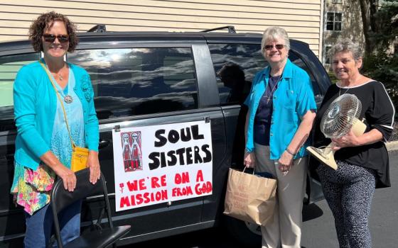 Kathy Shannon, left, who uses her van to help transport donated furniture, poses with Sr. Francis Margaret Maag, center, and Geri Herbst outside Speers Court Apartments in Dayton, Kentucky, in October 2022. (Courtesy of Francis Margaret Maag)