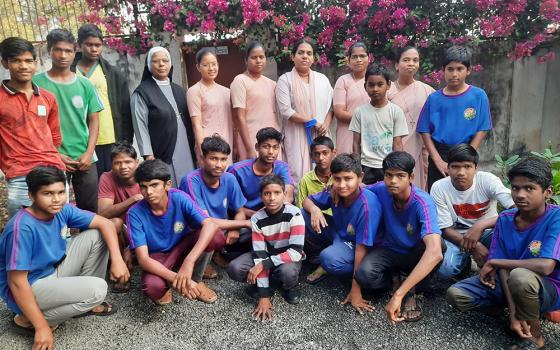 Members of the Daughters of Our Lady of the Garden convent are pictured with boys of Navjeevan, a care home for children rescued from railway platforms in Khandwa, central India. Sr. Ambika Pillai is third from the right in the back row. (GSR photo/Saji Thomas)