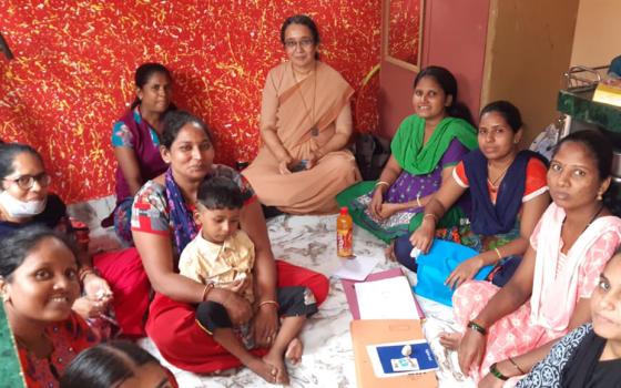 Canossian Sr. Catherine Gonsalves, center, a former pupil of Nirmala Niketan, with beneficiaries at a self-help group meeting in Mahim, a suburb of Mumbai, India (Courtesy of Catherine Gonsalves)