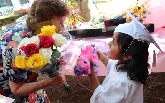 Dominican Sr. Jean Graffweg gives flowers to a House on the Hill student at their 2019 graduation ceremony. The facility in Goshen, New York, hosts a Head Start program that serves about 45 children ages 2 months to 5 years old. (Courtesy of Sisters of St. Dominic of Blauvelt, New York)