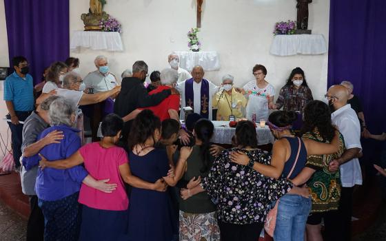 Members of a delegation to El Salvador and Honduras sponsored by the SHARE Foundation and the Leadership Conference for Women Religious pray during Mass celebrated by Honduran Jesuit Fr. Ismael Moreno Coto, known as Padre Melo, on Dec. 11, 2022. (SHARE Foundation/Mark Coplan)