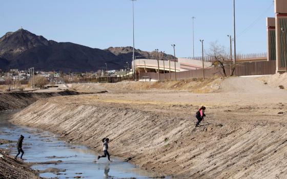 Migrants cross the Rio Bravo in Ciudad Juarez, Mexico, Feb. 4, 2021, to turn themselves in to U.S. Border Patrol in El Paso, Texas, to request asylum. (CNS/Reuters/Jose Luis Gonzalez)