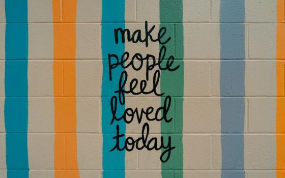 Written on a wall: Make people feel loved today