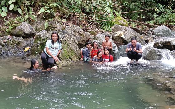 The author and her companions stopped for a quick swim in a river along the road of a mountain village in Nanga Nangan, Philippines. (Courtesy of Marjorie Guingona)