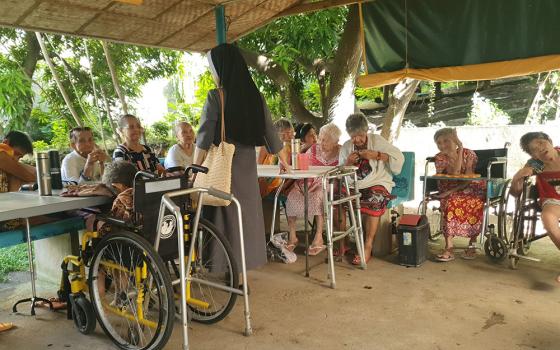 Residents of Mary Mother of Mercy Home for the Elderly and Abandoned in San Pedro, Laguna, Philippines, gather in the home's outdoor hut to recite the Divine Mercy prayer and the rosary. They also watch TV there. (Oliver Samson)