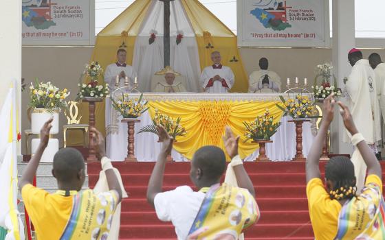 A woman waits for the start of Pope Francis' celebration of Mass at the John Garang Mausoleum in Feb. 5 in Juba, South Sudan. (CNS/Paul Haring)