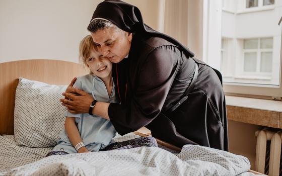 Sr. Michaela Rak with a hospice patient 