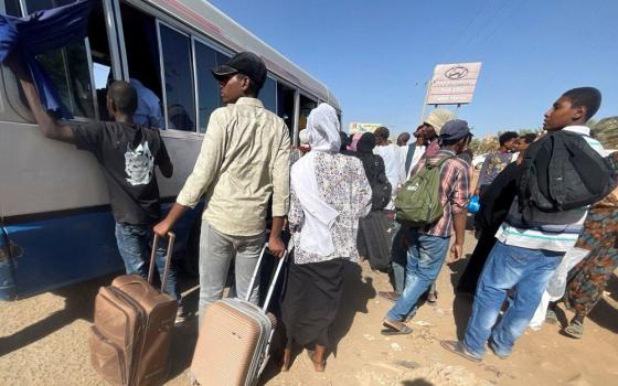  People fleeing clashes between the paramilitary Rapid Support Forces and the army gather at the bus station in Khartoum, Sudan, on April 19. (OSV News/Reuters/El-Tayeb Siddig)