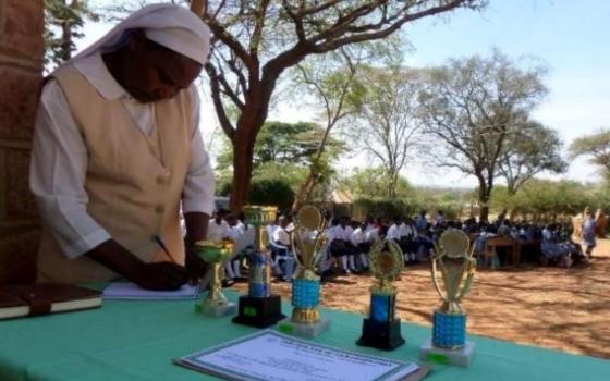 Sr. Josephine Kwenga prepares certificates and trophies to students during an annual commemoration of World Environmental Day in the Machakos Diocese, Kenya. (Courtesy of  AOSK)