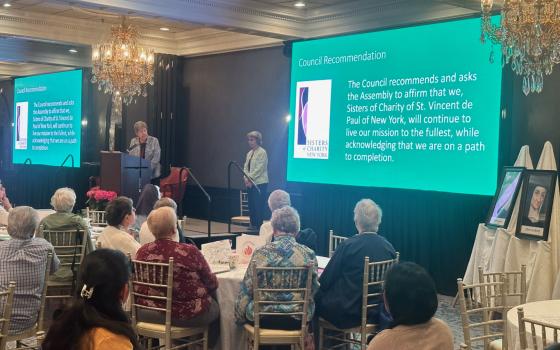 Sr. Donna Dodge, president of the Sisters of Charity of New York, reads the executive council's recommendation on the congregation's path to completion at their 2023 general assembly. (Courtesy of the Sisters of Charity of New York)