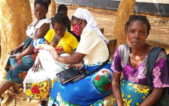 Mercy Sr. Christabel Kazembe interacts with mothers and their children during one of her community outreach programs with Strengthening the Capacity of Religious Women in Early Childhood Development (SCORE-ECD) in Zambia. (Courtesy of Christabel Kazembe)