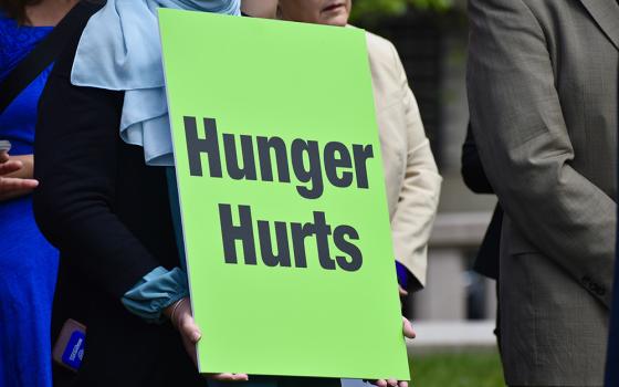 1 A participant at the "Care Not Cuts" rally holds a sign reading "Hunger hurts" April 26 in Washington. (Courtesy of Network Lobby/Catherine Gillette)
