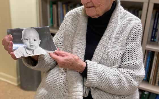 Dominican Sr. Jeanne Clark holds the photo she carried when she was charged with "obstructing a lawfully operated train" (Courtesy of Elizabeth Keihm)