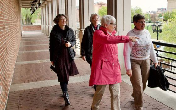 Women Touched by Grace participants, from left, the Rev. Julie Webb, Benedictine Sr. Betty Drewes, Benedictine Sr. Mary Luke Jones and the Rev. Tamara Franks walk the grounds at the Indiana Historical Society in Indianapolis on April 28. (GSR photo/Dan Stockman)