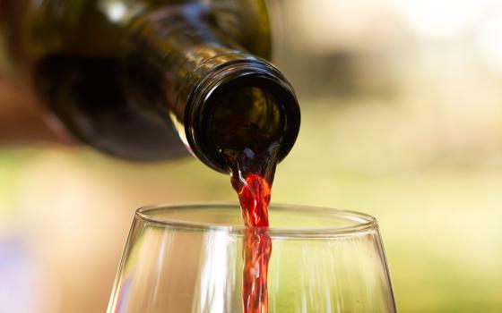 Pouring wine (Unsplash/Christine Isakzhanova)
