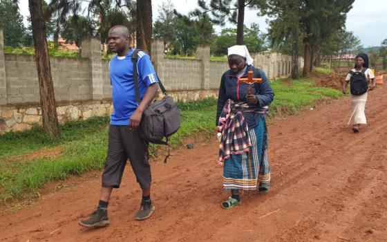 Sr. Mary Olive Masibo and Fr. Dennis Paddy Wandera make their way to the Uganda Martyrs Shrine Namugongo to honor the 22 Catholic Uganda martyrs who were murdered for refusing to denounce their faith. (GSR photo/Gerald Matembu)