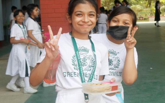 Two students pose for a photo on the grounds of the S.F.X. Greenherald International School in Dhaka, Bangladesh. The school is the first English-language school in Bangladesh after the country's independence in 1971. (Uttom S. Rozario)