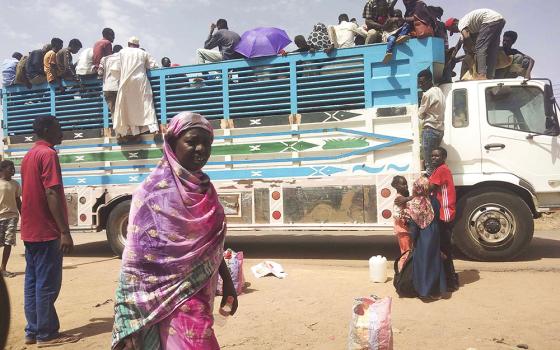 People board a truck as they leave Khartoum, Sudan, on June 19. Clashes resumed between Sudan's military and a powerful paramilitary force after a three-day cease-fire expired June 21. (AP, file)