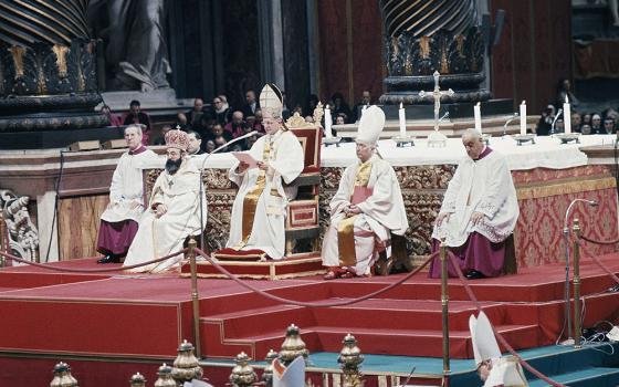Pope Paul VI proclaims the last decrees of the Second Vatican Council, sitting on his throne before the papal altar under Bernini's bronze canopy in St. Peter's Basilica in Vatican City, Dec. 7, 1965. (AP)