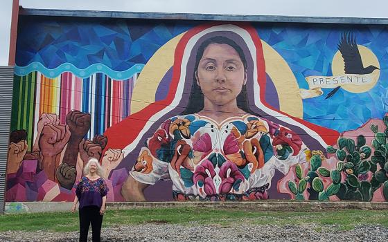 Sr. Martha Ann Kirk stands by “Mujerista #3" Mural No. 57, community art sponsored by the San Antonio Cultural Arts Center. The lead artists are Ana Hernandez and Rhys Munro. Kirk's name is painted on the right as a community member who encouraged this creation. (Courtesy of Martha Ann Kirk)