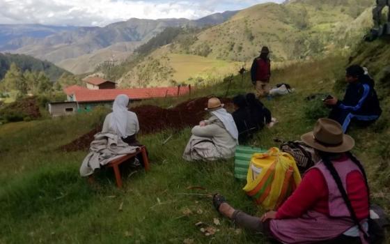 Farmers and residents of the village of Cotacombas, Peru, share a lunch of chicken stew in the countryside. Augustinian Sisters of the Conversion Monastery spent 10 days with the community in the Andes. (Courtesy of Diana Villarreal) 