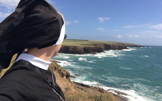 The author is pictured on a hike along the Dunmore East Cliff Walk in County Waterford, Ireland, during her annual retreat in August 2022. (Courtesy of Kathryn Press)