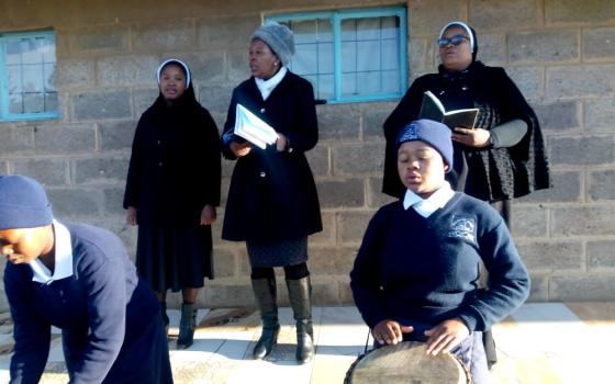 Students and staff at Maryland High School's assembly singing the Blessed Mother Marie-Rose hymn to celebrate the anniversary of her beatification. In the back row, left to right, are Sr. Lydia Lerato Rankoti, Miss Rannoni and Sr. Lucia Matima. Students Mosa Mokhakala (left) and Ithabeleng Montoeli play drums. (Courtesy of Lydia Lerato Rankoti)