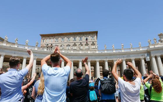 Visitors applaud and greet Pope Francis after praying the Angelus in St. Peter's Square at the Vatican July 9. (CNS/Lola Gomez)