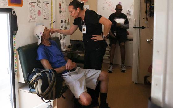 A man from a homeless encampment receives care from Circle The City's mobile medical unit on the 14th day of temperatures rising to 114 degrees Fahrenheit July 13 in Phoenix. Bishop Edward Weisenburger of the Diocese of Tucson, Arizona, calls climate change a critical topic. (OSV News/Reuters/Liliana Salgado)