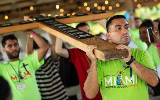 Gustavo Mejia, youth director at St. Joseph Parish in Miami Beach, helps carry the South Florida World Youth Day Cross during Mass Aug. 6, 2023, concluding a weeklong series of parallel World Youth Day events Aug. 1-6 mirroring those that took place in Lisbon, Portugal, for those unable to travel there. (OSV News photo/Tom Tracy) 