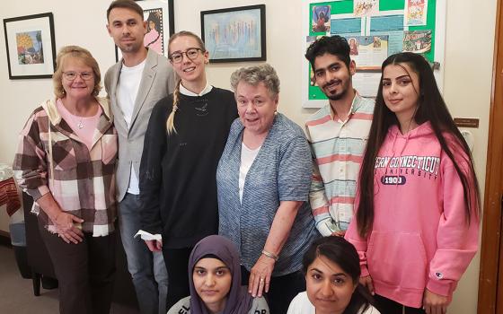 Sr. Karen Burke, left, Sr. Annelle Fitzpatrick, center, are flanked by refugees the Sisters of St. Joseph of Brentwood in Brentwood, New York, have welcomed onto their campus. (GSR photo/Chris Herlinger)