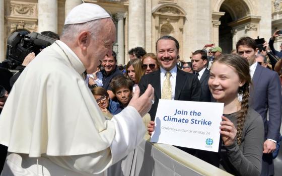 Pope Francis greets Swedish climate activist Greta Thunberg during his general audience in St. Peter's Square at the Vatican in this file photo from April 17, 2019.