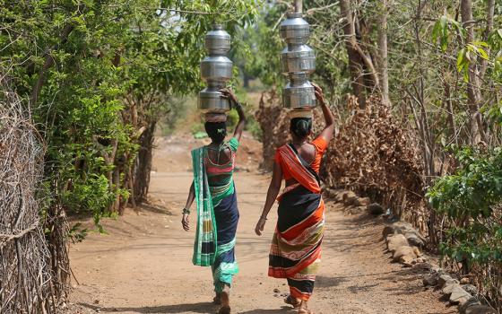 Women in Thane, India, carry water to their houses May 30, 2019. (CNS/Reuters/Francis Mascarenhas)