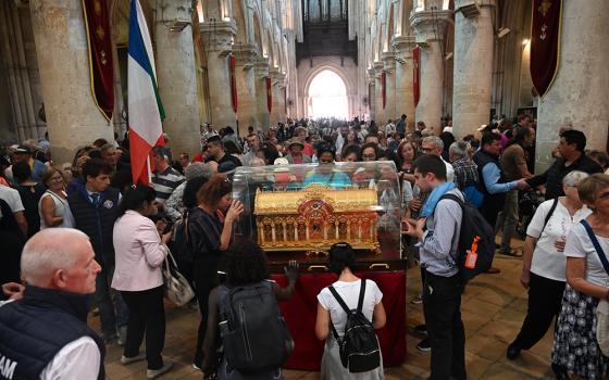 Pilgrims pray over the reliquary of St. Thérèse of Lisieux Oct. 1 in Lisieux, France. Nearly 30,000 pilgrims flocked to Lisieux for the so-called Theresian feasts, celebrated Sept. 30-Oct. 8 in France's northern Normandy region, where the famous French saint, born Jan. 2, 1873, lived and died. (OSV News/Courtesy of Sanctuary of St. Thérèse of Lisieux)