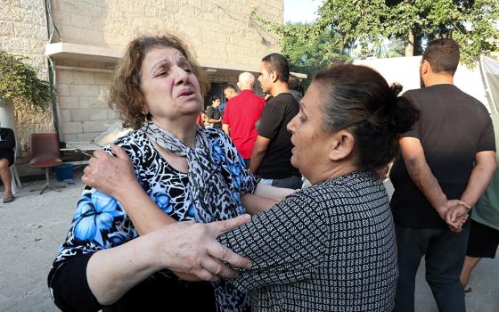 Women react outside St. Porphyrios Greek Orthodox Church in Gaza Oct. 20 after an explosion went off the night before. Several hundred people had been sheltering at the church complex, many of them sleeping, at the time of the explosion. The Hamas Ministry of Interior in Gaza blamed the explosion on an Israeli airstrike but responsibility for it had not yet been independently verified. (OSV News/Reuters/Mohammed Al-Masri)