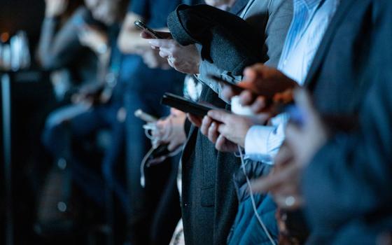 Photo illustration of people using phones (Unsplash/Camilo Jimenez)