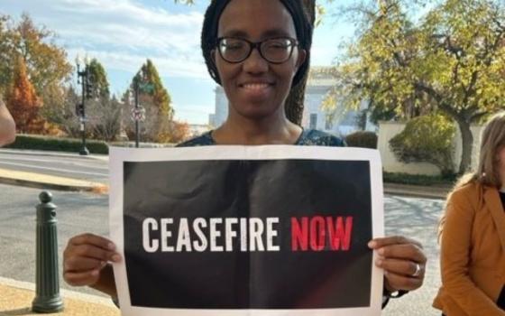 Woman holds sign: "Ceasefire Now"