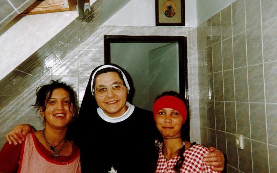 Sr. Atanazia Holubova poses with Romani teenage girls while baking cookies in the Pastoral Center for Romani in Poštarka, Slovakia. (Courtesy of Emanujila Vishka)