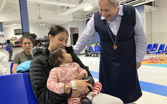 Sr. Norma Pimentel, a Missionary of Jesus, greets Esther Chicas, a recently arrived migrant from El Salvador, and her child, Andrea, at the Humanitarian Respite Center in McAllen, Texas on Nov. 11. Pimentel has urged Catholics to "defend life" through projects such as Catholic Charities' work with the migrant population, especially at the border. (OSV News/David Agren)