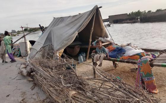 A family home beside floodwaters in the province of Sindh in Pakistan in 2022 (Courtesy of Emer Manning)