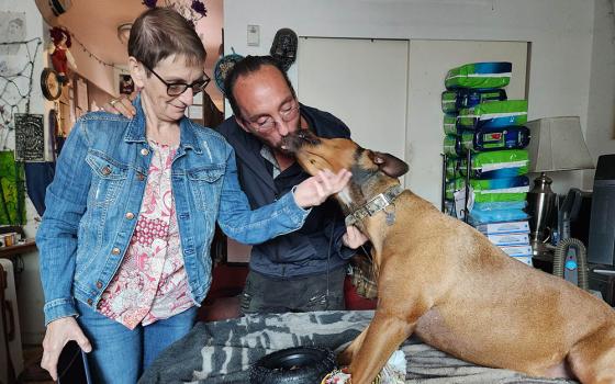 Tommy Dunphy and his beloved dog, Arianna, with friend Sr. Margaret Farrell, left, in Dunphy's small studio apartment (GSR photo/Chris Herlinger)