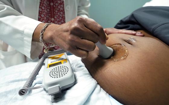 A doctor uses a hand-held Doppler probe on a pregnant woman to measure the heartbeat of the fetus, Dec. 17, 2021, in Jackson, Mississippi. (AP/Rogelio V. Solis, File)