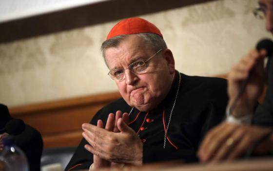 Cardinal Raymond Burke applauds during a news conference at the Italian Senate, in Rome, on Sept. 6, 2018. Pope Francis has taken measures to punish one of his highest-ranking critics, Cardinal Raymond Burke, by yanking his right to a Vatican apartment and salary in the second such radical action against a conservative American prelate this month, according to two people briefed on the measures. (AP Photo/Alessandra Tarantino, File)