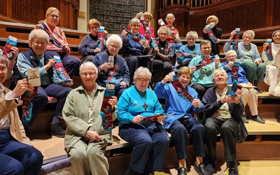 School Sisters of St. Francis singers receive St. Cecilia socks at their final rehearsal before their "Gathering on Holy Ground" concert in November 2022 to celebrate the reopening of St. Joseph Chapel in Milwaukee. (Courtesy of Jane Marie Bradish)