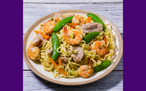 A plate of pancit canton is pictured. On special days like Christmas, pancit was a favorite holiday dish that Terri Laureta's aunt would make, a savory combination of egg noodles, rice noodles, meat and vegetables. (Flickr/Joost Nusselder, BiteMyBun.com, CC BY 2.0 Deed)