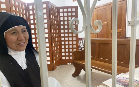 Behind the grille at the 130-year-old St. Joseph of Guadalupe Monastery, Discalced Carmelite Sister Dora Patricia del Jesús Resucitado explains a bit about its history Aug. 27 near the grounds of the Our Lady of Guadalupe Basilica in Mexico City. (GSR photo/Rhina Guidos)