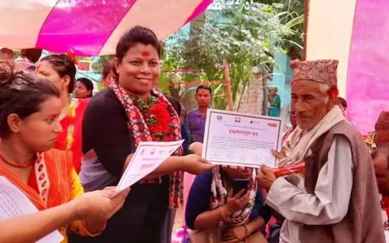 Sr. Durga Cecilia Shrestha (center), a member of the Sisters of St. Joseph of Cluny and the first woman executive director of Caritas Nepal seen at a program with beneficiaries. (Courtesy photo)