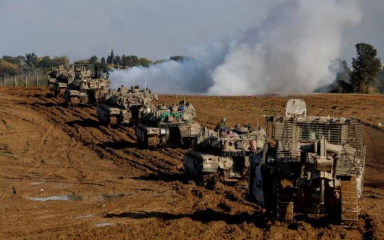 Israeli military vehicles move out of the Gaza Strip, as seen from southern Israel Jan. 15, amid the ongoing conflict between Israel and the Palestinian Islamist group Hamas. 