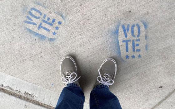 illustration of a person's feet on a sidewalk, with words "vote"
